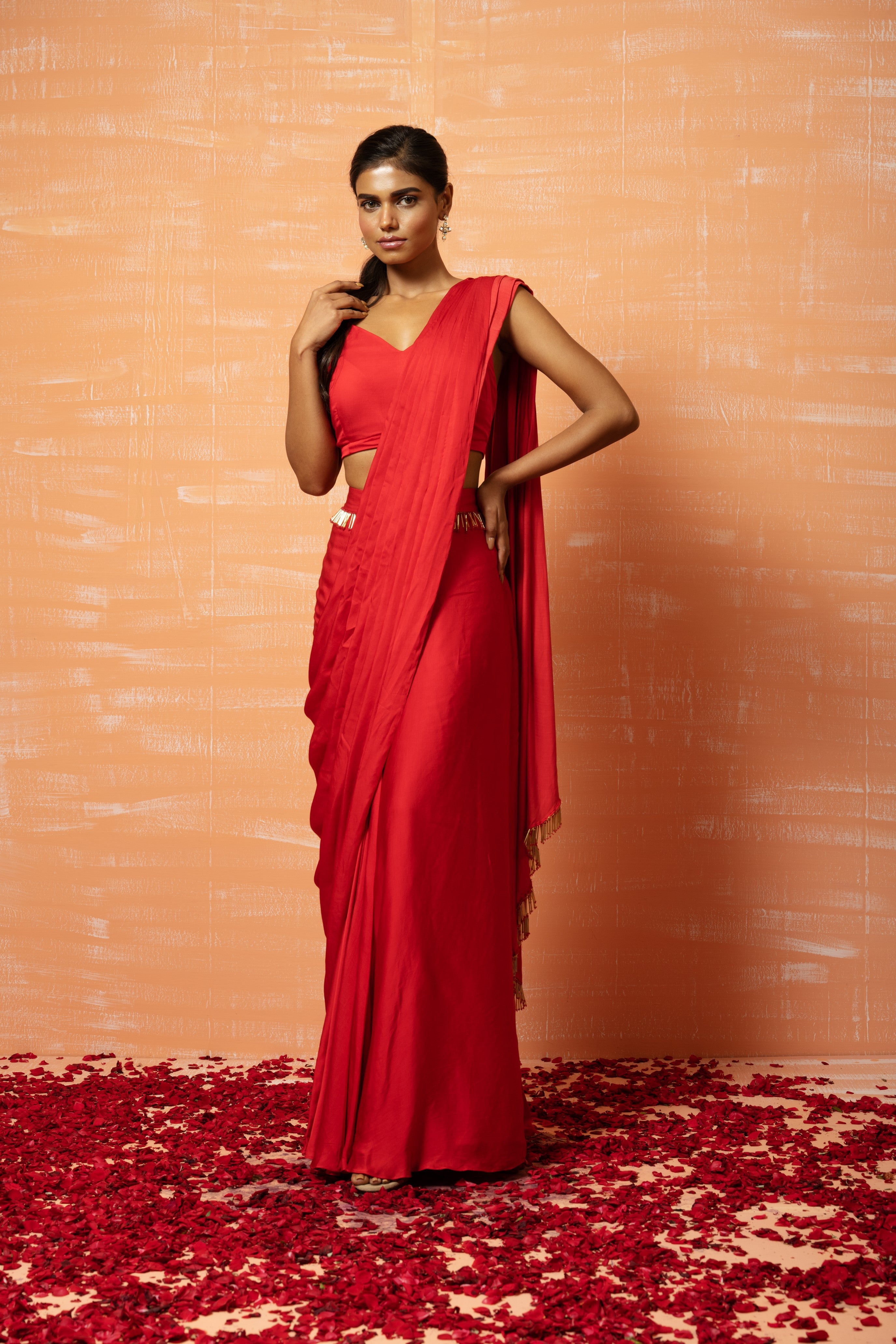 Red pre-stitched saree in modal silk with lace embellishments.