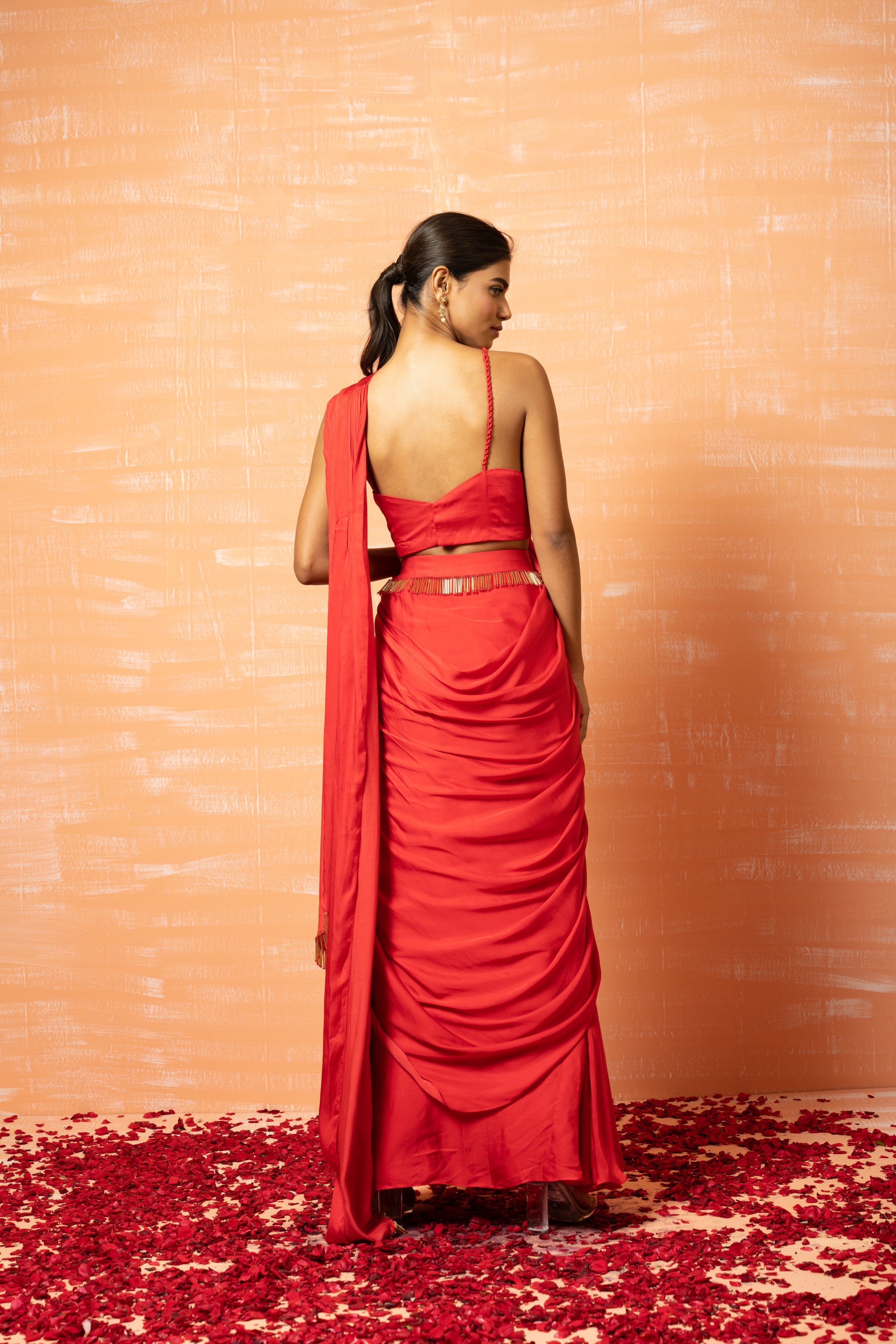 Red pre-stitched saree in modal silk with lace embellishments.