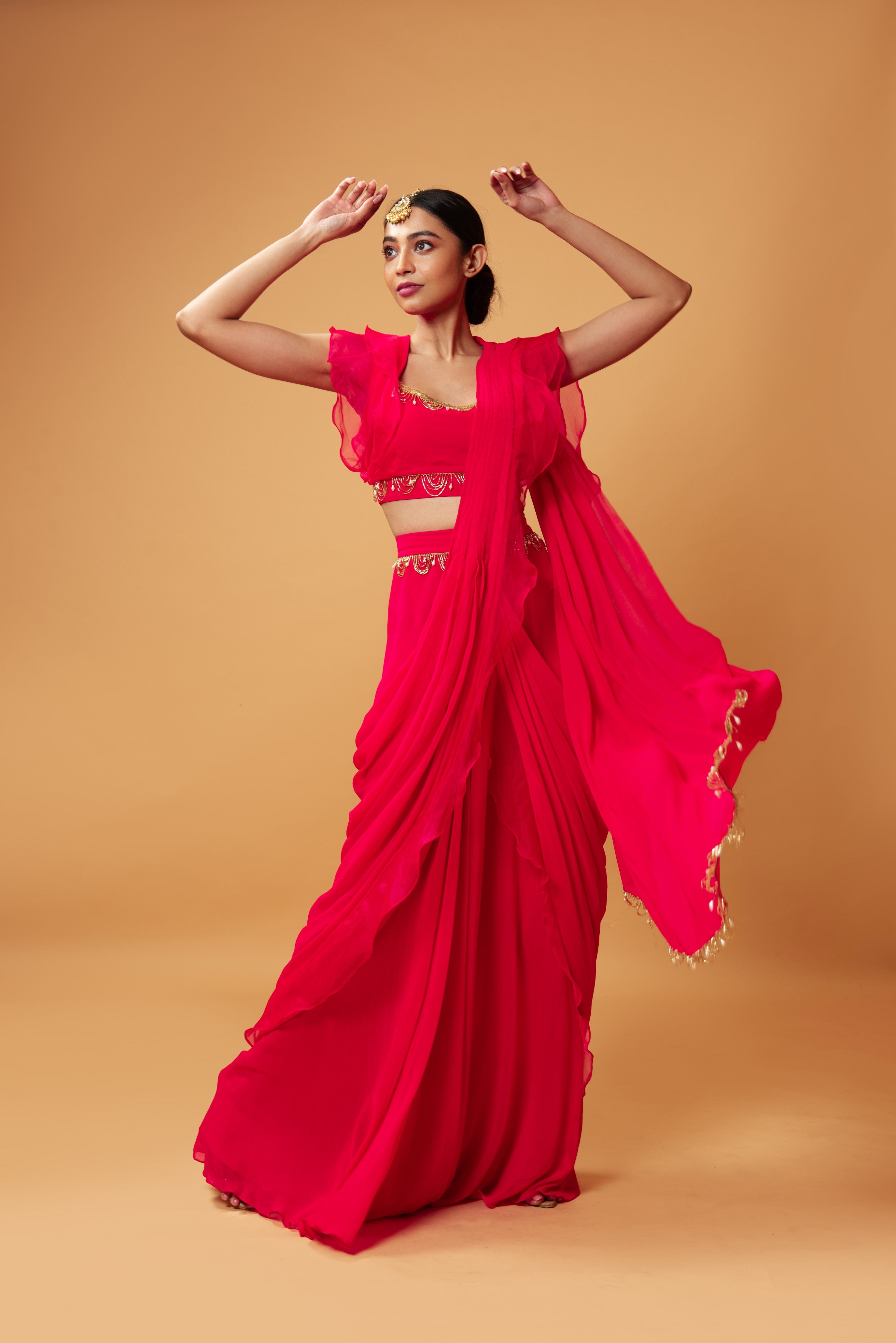 Fuschia pink ruffle saree with lace detailing on neckline and waist.