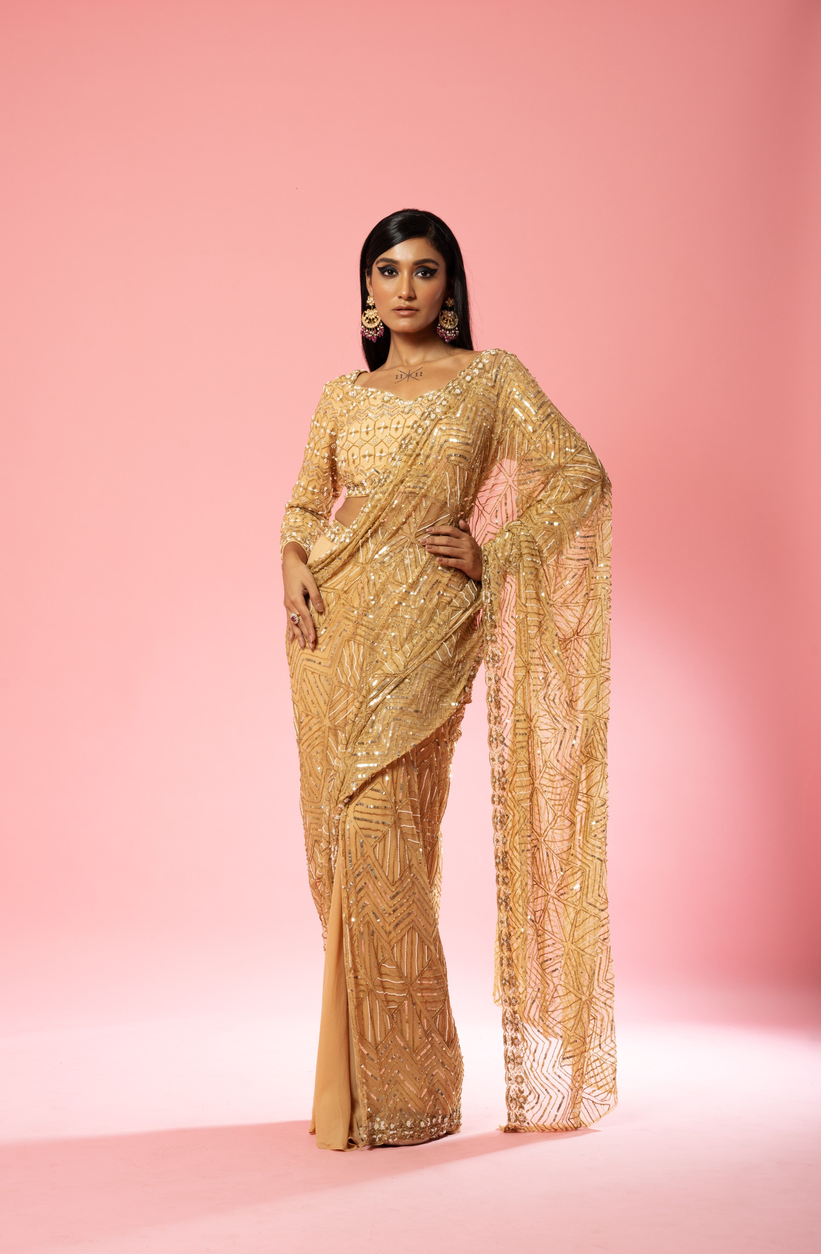 Golden pre-stitched saree with intricate hand embroidery.