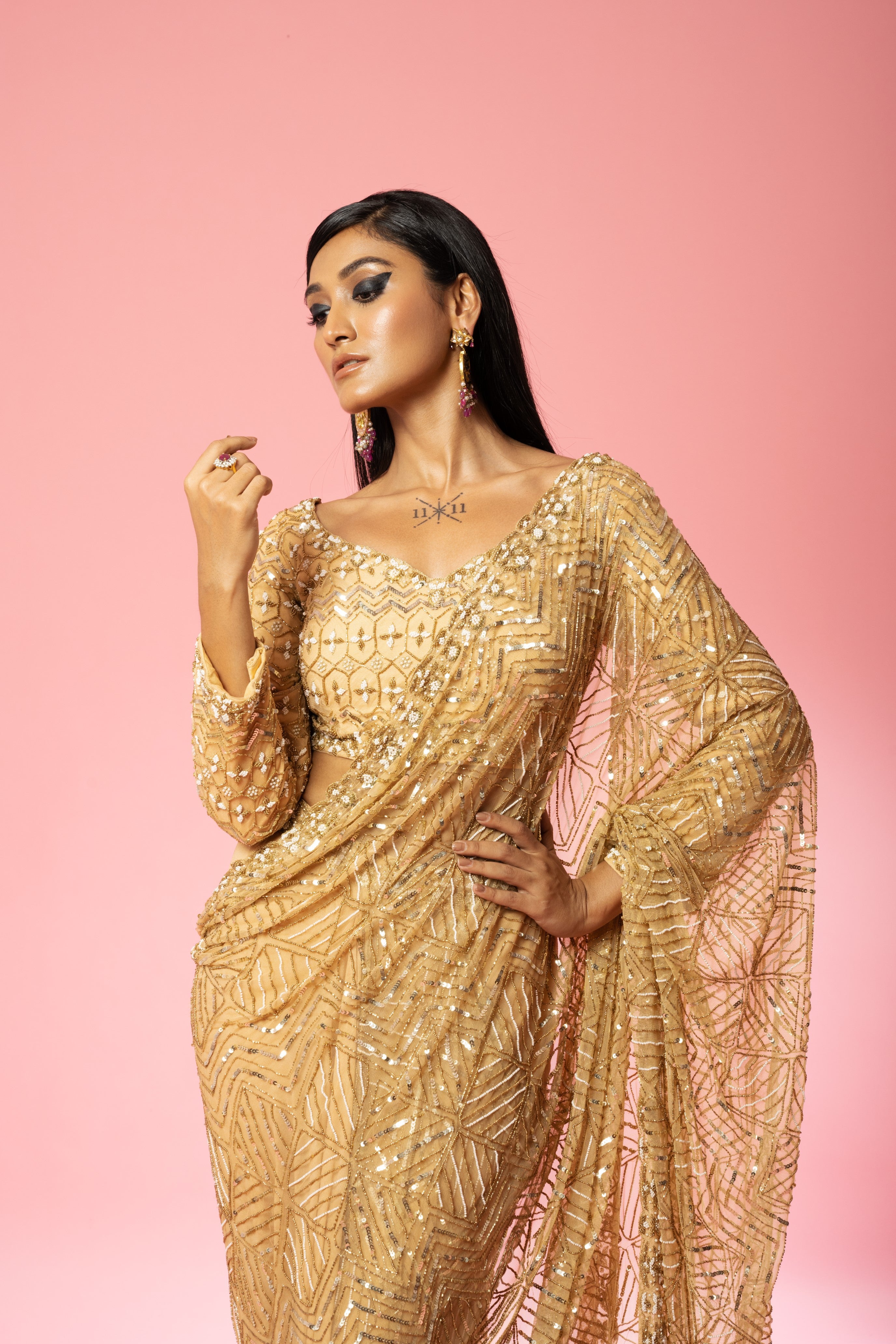 Golden pre-stitched saree with intricate hand embroidery.