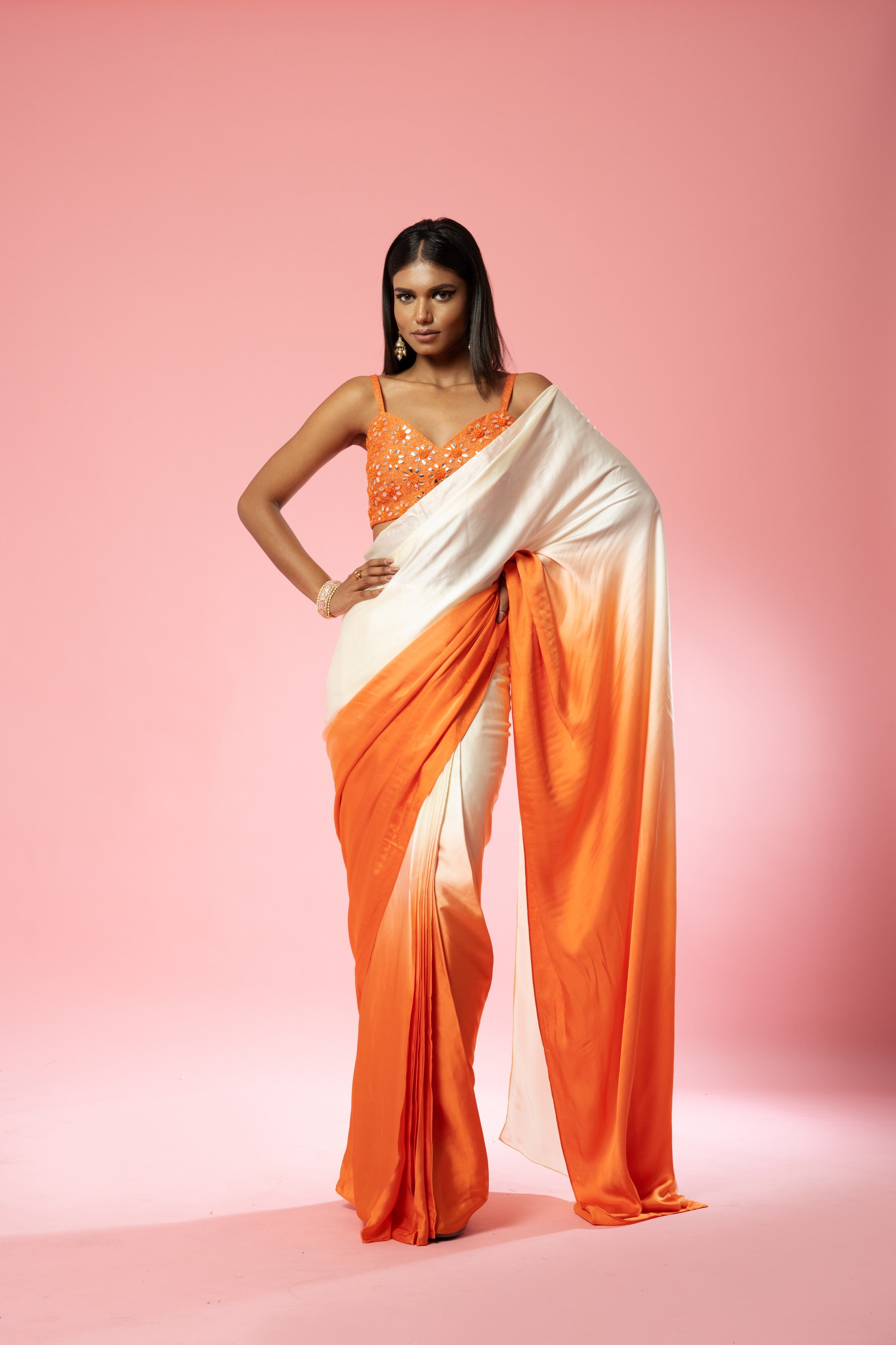 Ivory and orange ombre saree with hand-embroidered blouse.