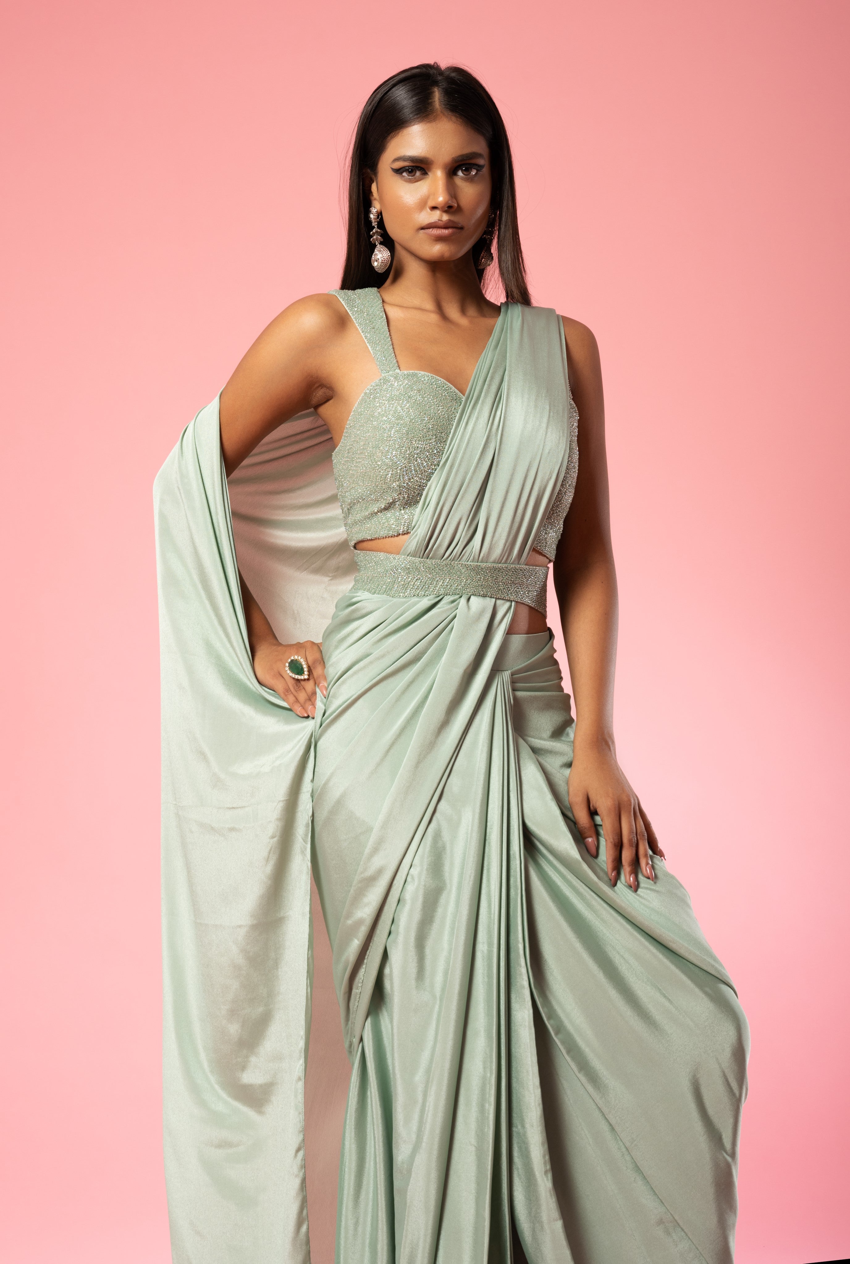 Sage green pre-stitched saree with hand-embroidered blouse and belt.