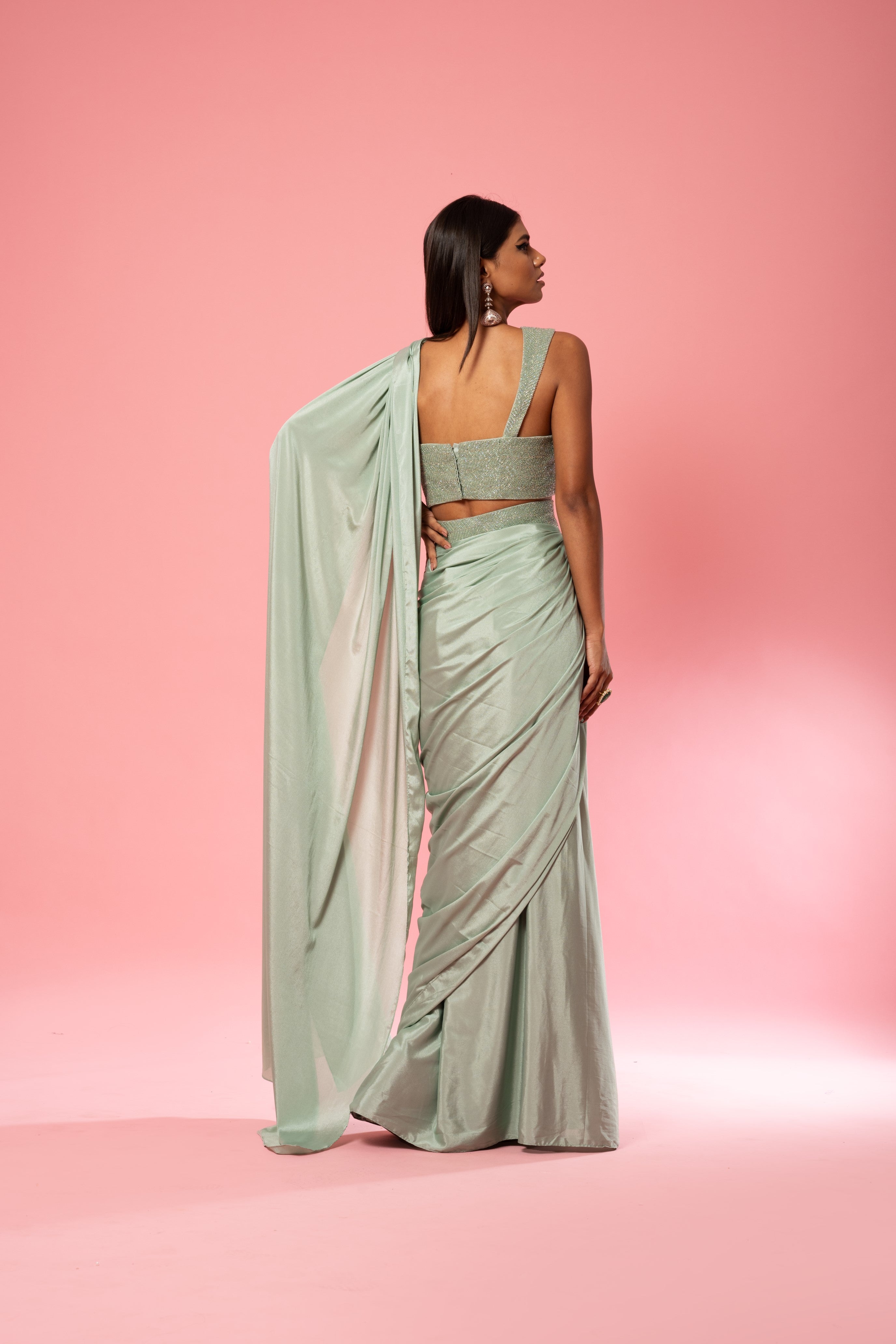 Sage green pre-stitched saree with hand-embroidered blouse and belt.