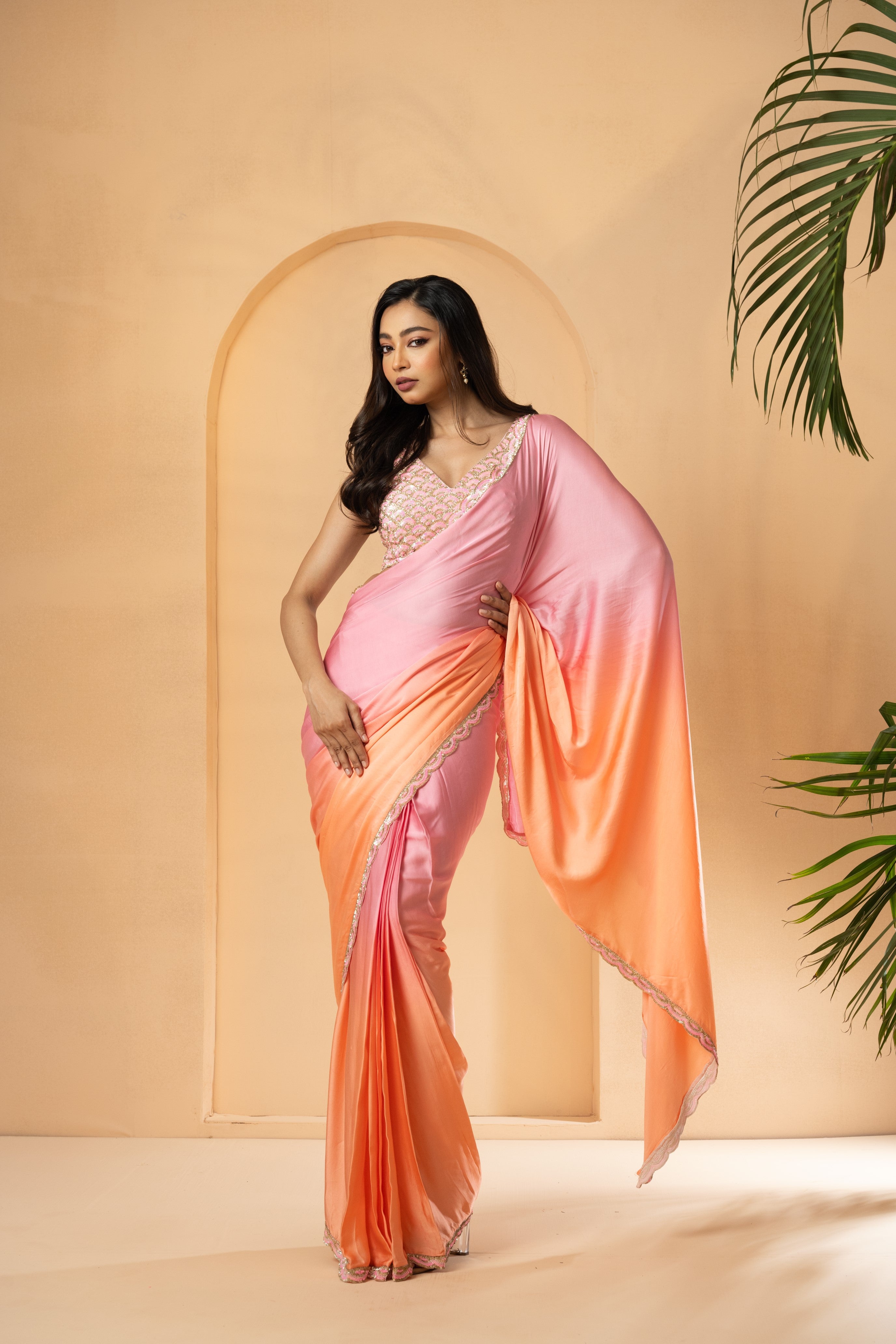 Pink and peach ombré pre-stitched saree with sequin-embellished blouse and border.