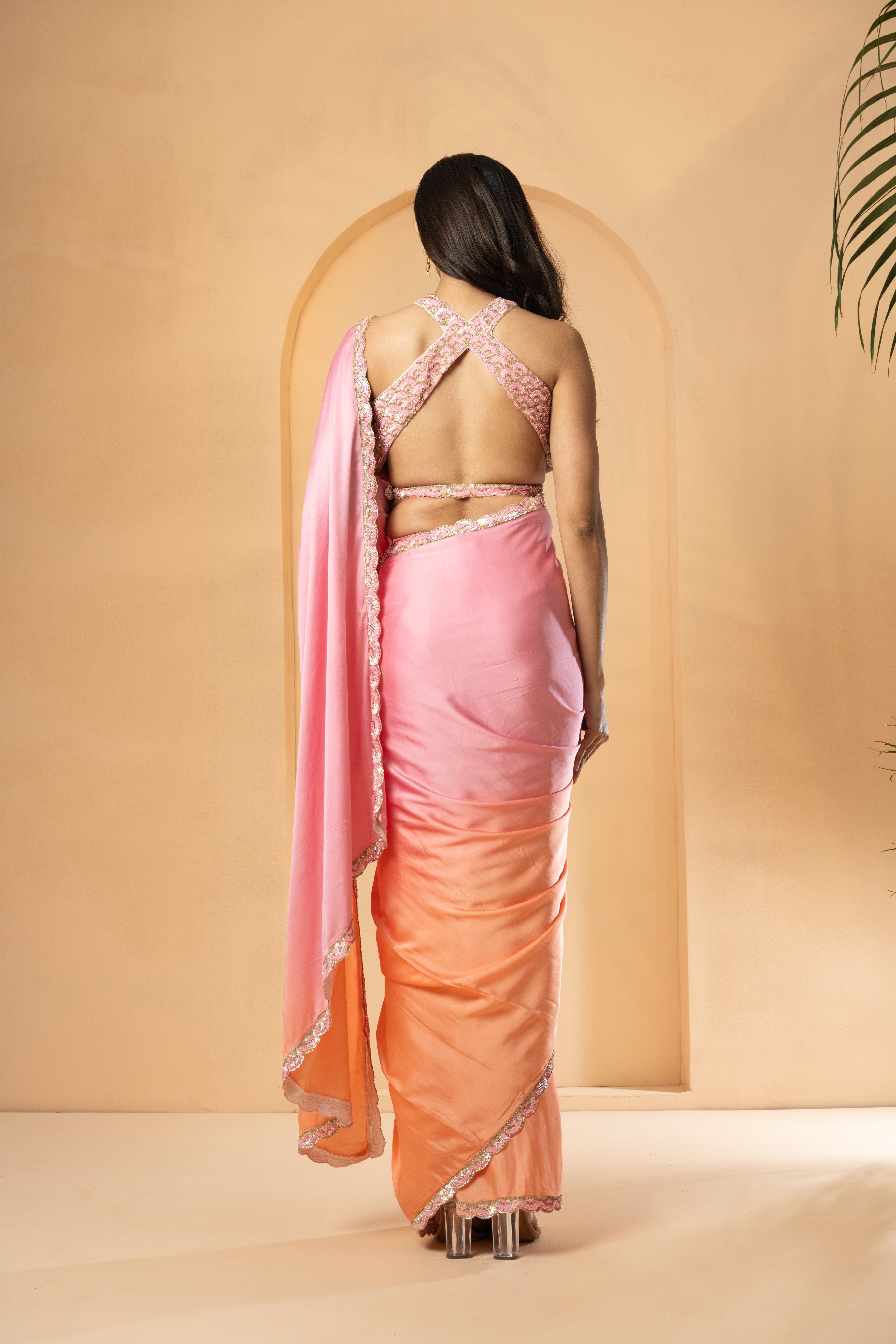 Pink and peach ombré pre-stitched saree with sequin-embellished blouse and border.