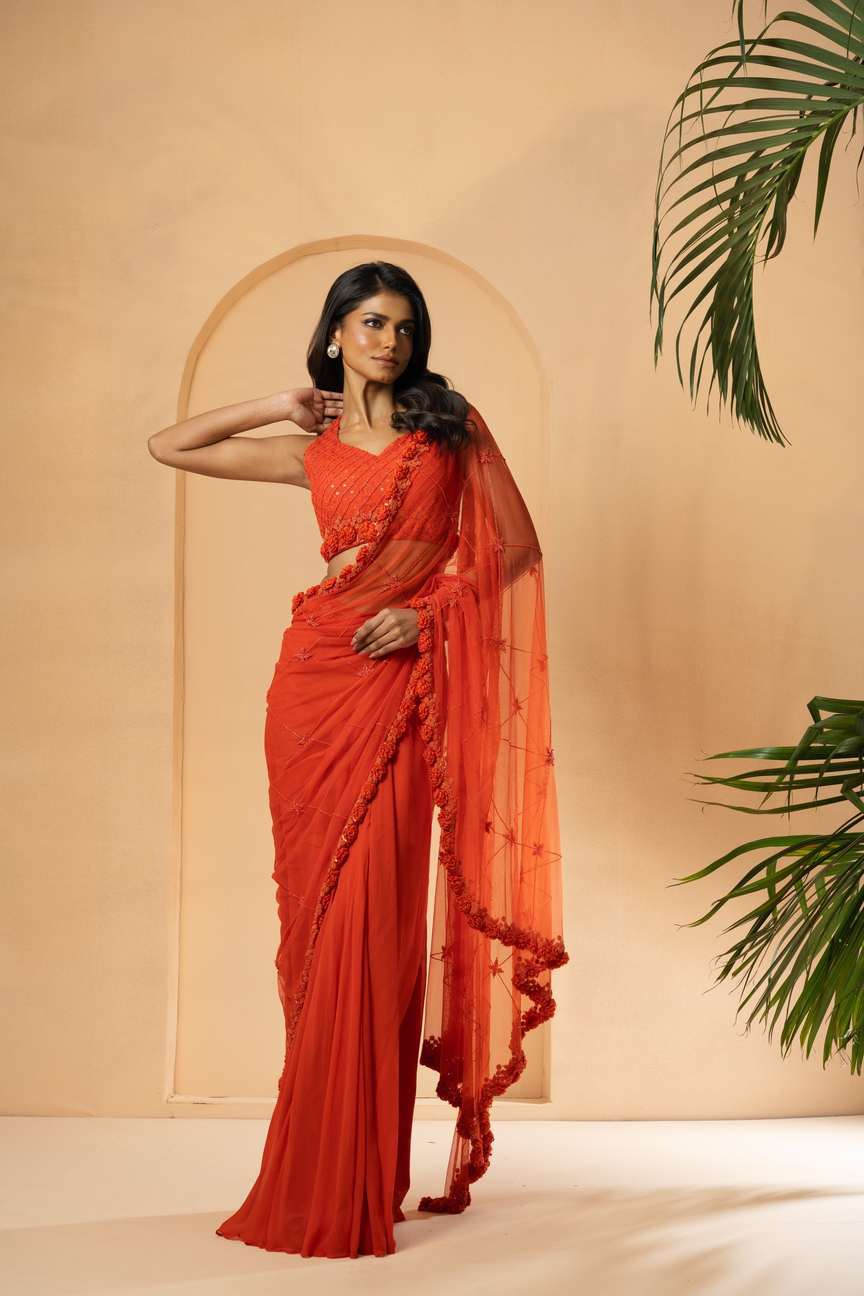 Orange pre-stitched drape saree with self-on-self embroidery in georgette and net.