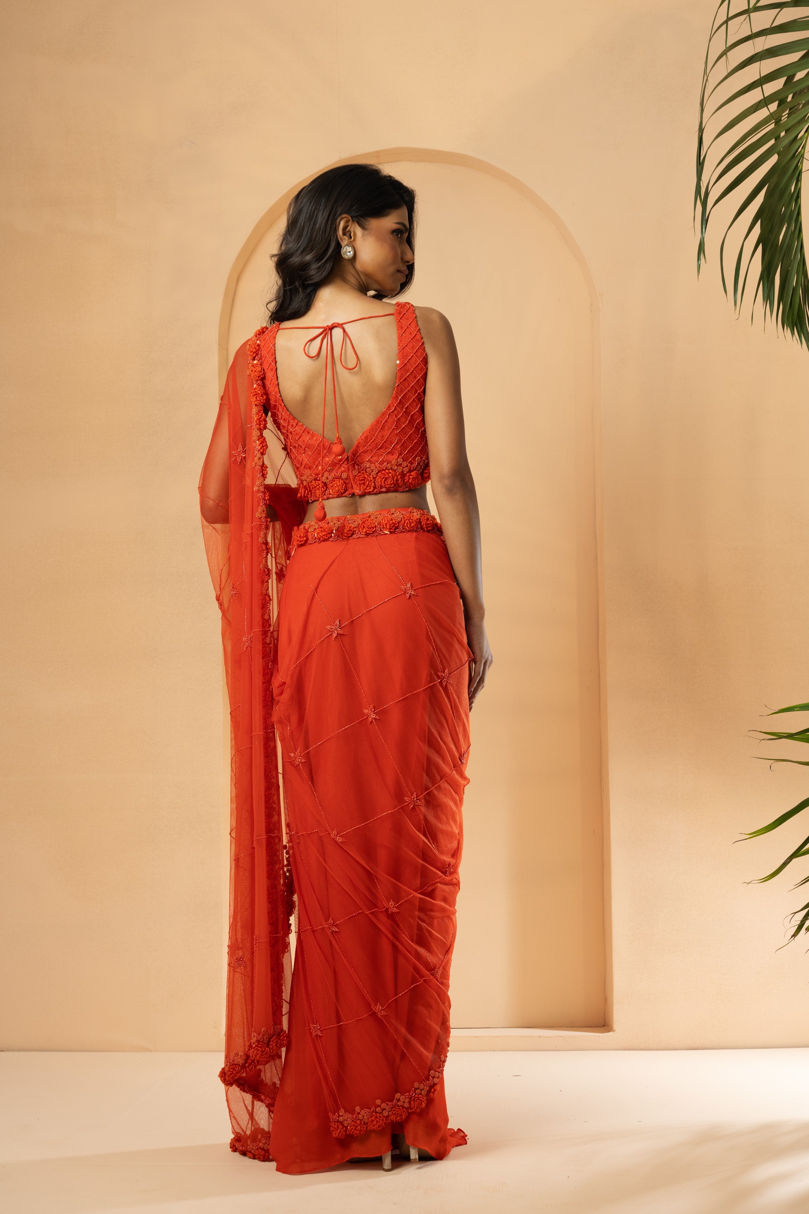 Orange pre-stitched drape saree with self-on-self embroidery in georgette and net.