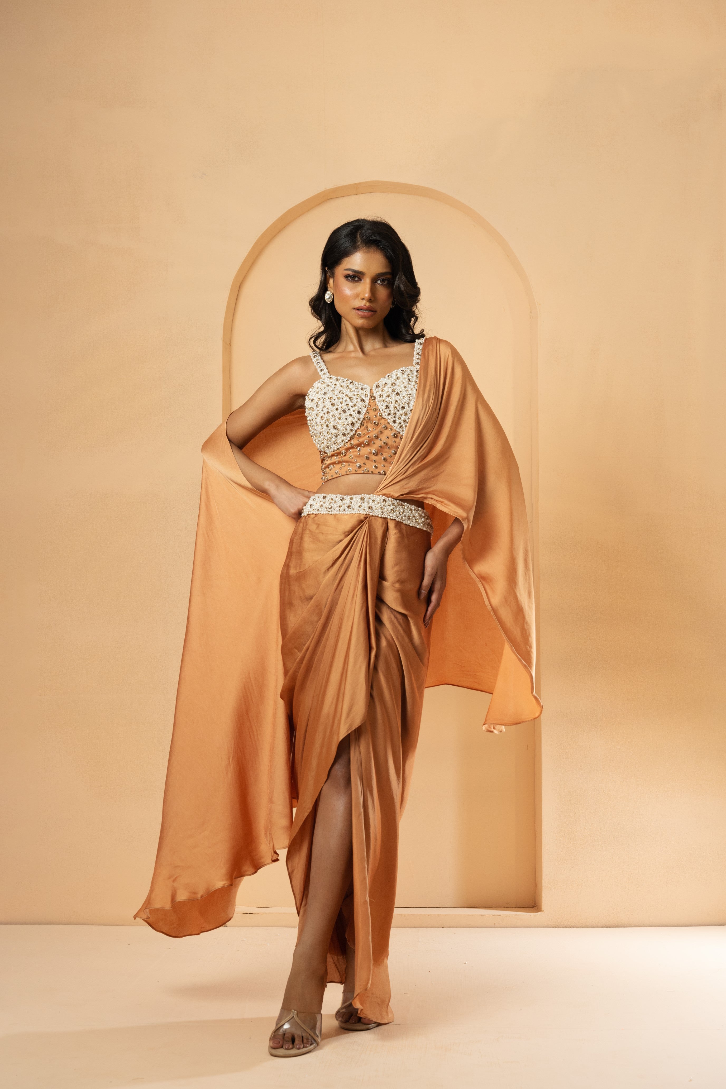 Golden pre-stitched corset saree with intricate embroidery.