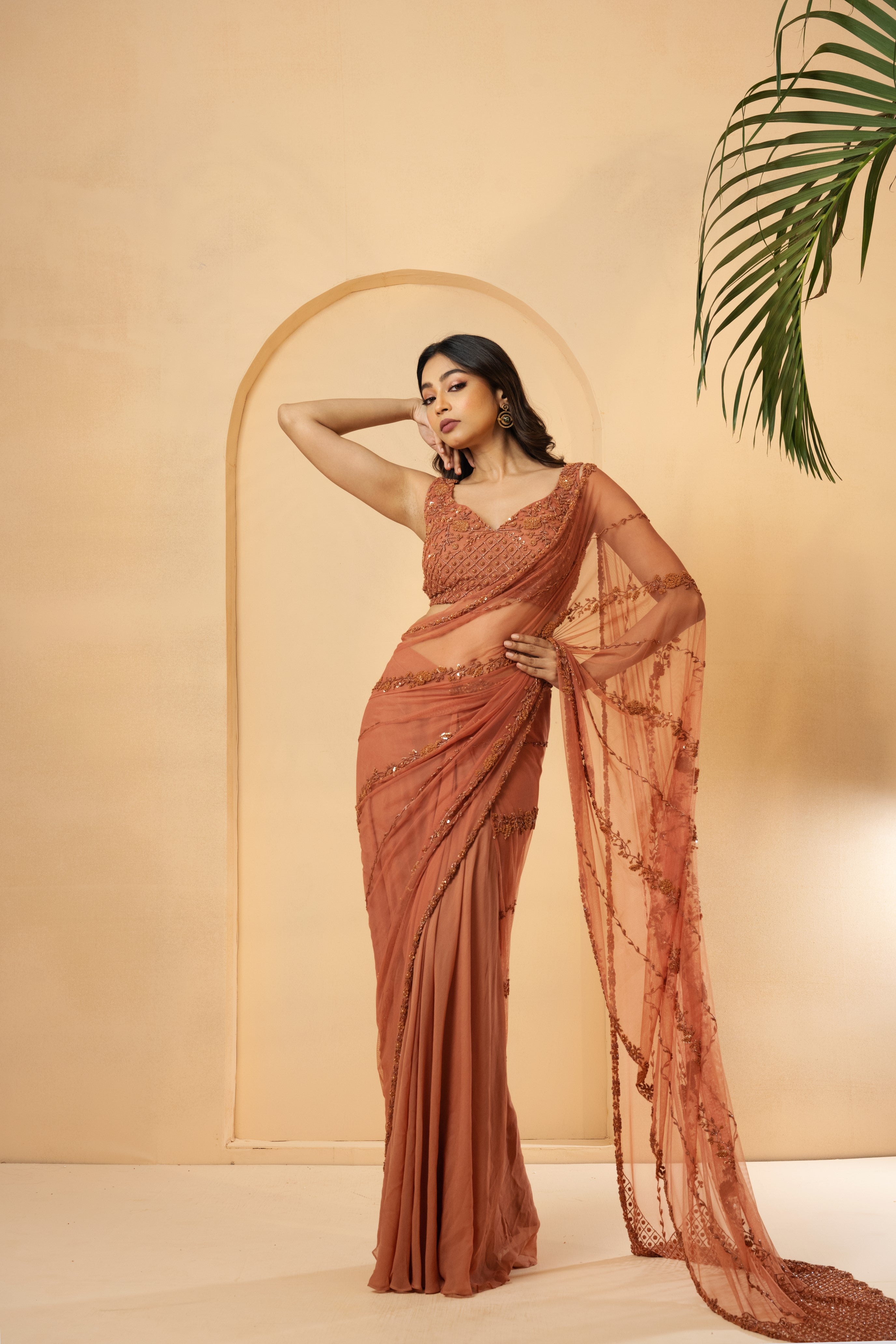 Dust pink pre-stitched drape saree with embroidered blouse and pallu.