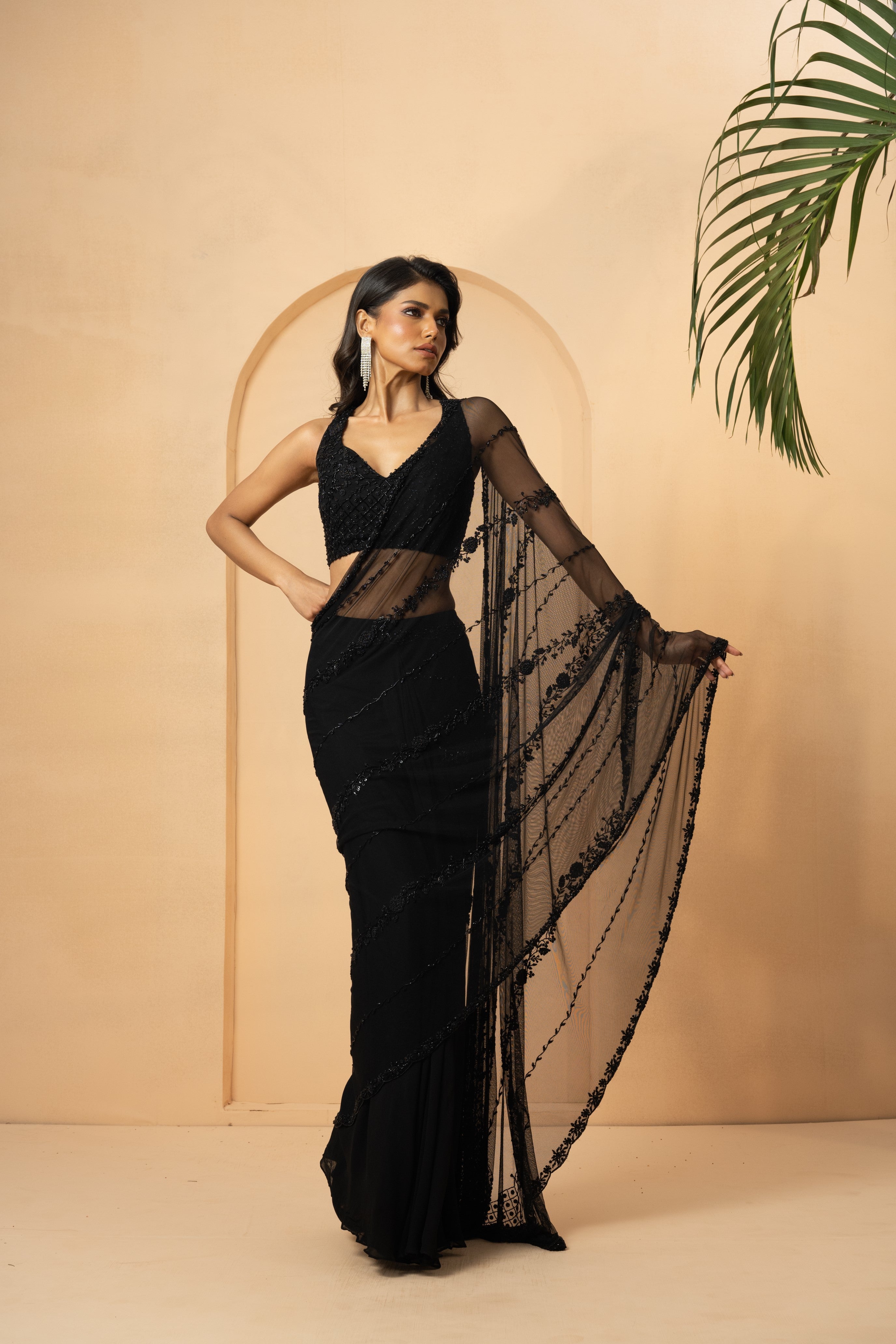 Black pre-stitched saree with embroidered blouse and pallu detailing.