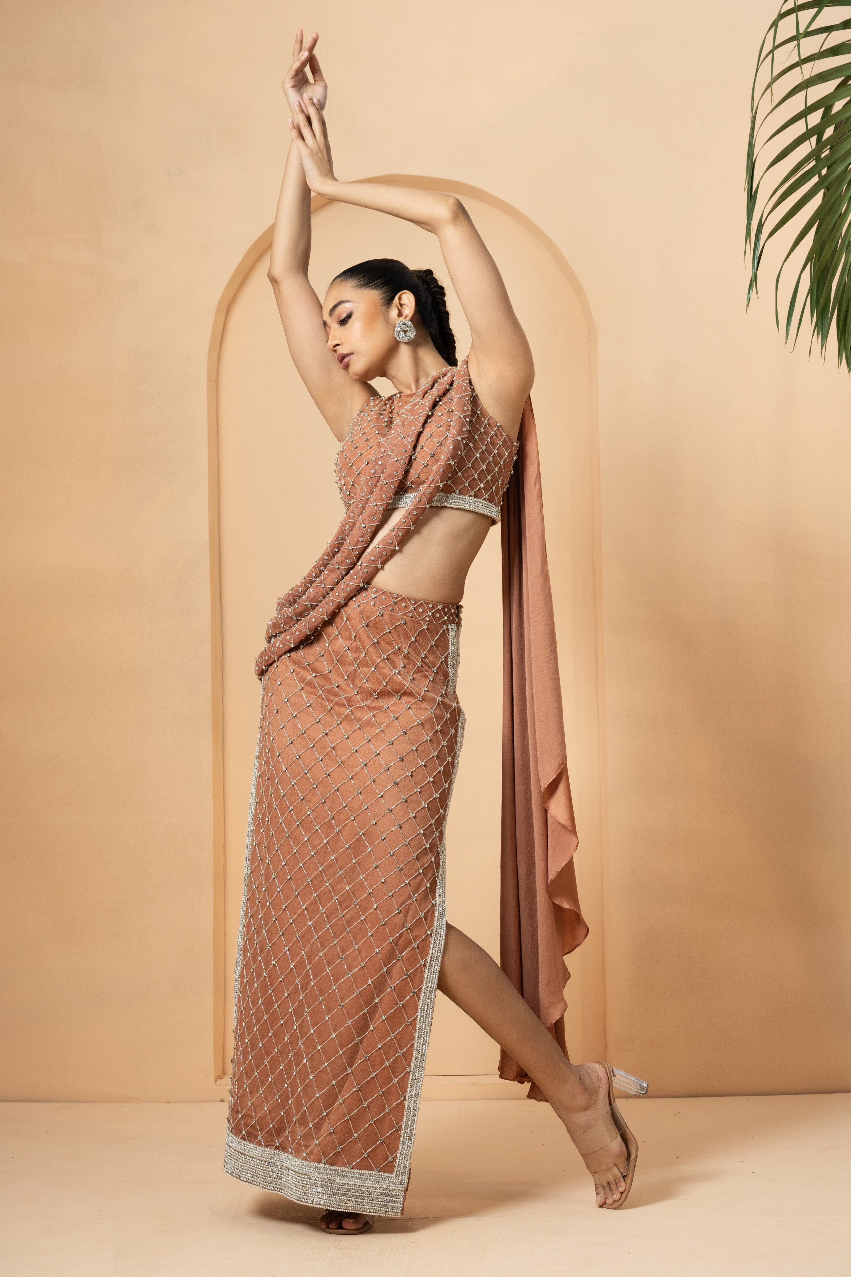 Beige saree with twisted drape dupatta and intricate hand embroidery.