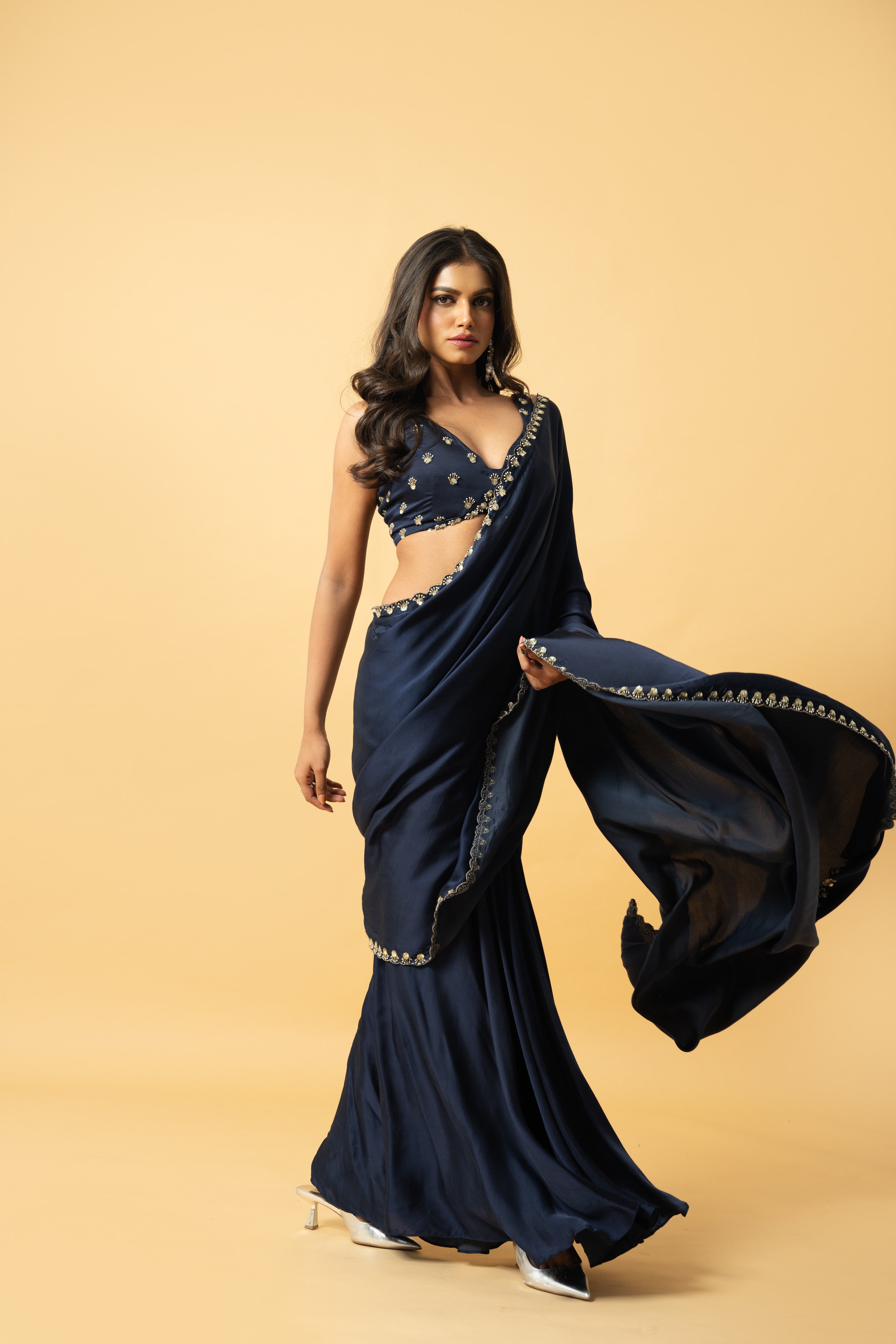 Blue modal satin saree with a hand-embroidered sleeveless blouse.