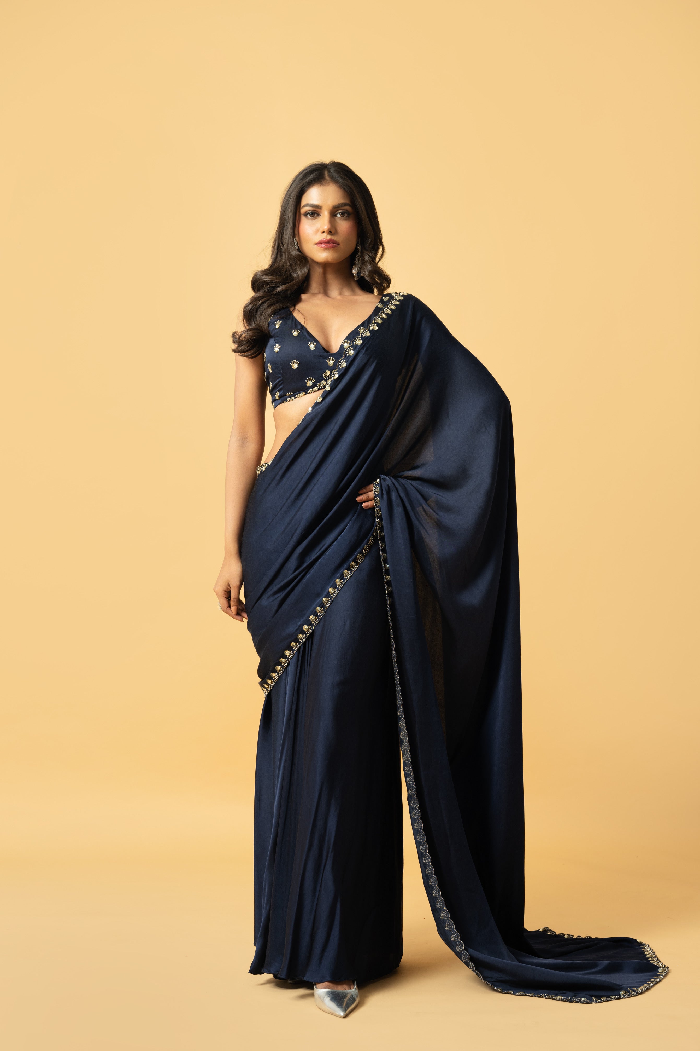 Blue modal satin saree with a hand-embroidered sleeveless blouse.